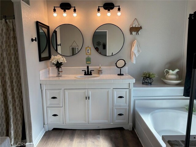 2033 Hollister Rd, Pinon Hills, CA 92372 - bathroom with vanity, wood finished floors, and a bath