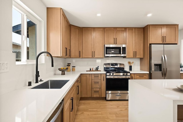 101 Coolwater Dr, San Diego, CA 92114 - kitchen featuring appliances with stainless steel finishes, light wood-type flooring, light countertops, recessed lighting, and brown cabinets