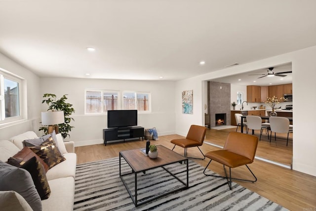 101 Coolwater Dr, San Diego, CA 92114 - living area with light wood finished floors, recessed lighting, and a fireplace