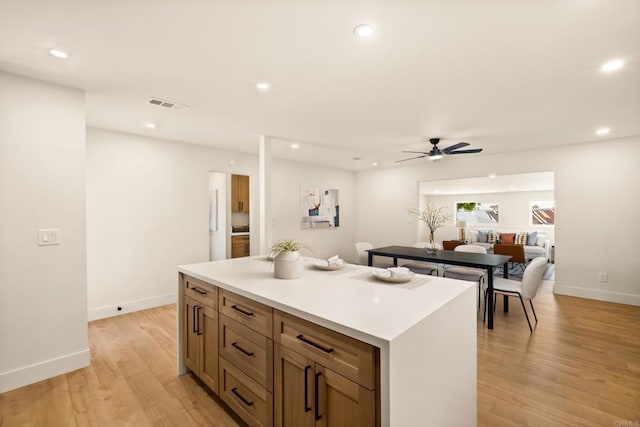 101 Coolwater Dr, San Diego, CA 92114 - kitchen featuring a ceiling fan, light wood-style floors, a center island, recessed lighting, and light countertops