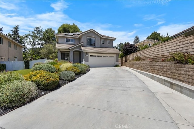 2517 Renata Ct, Thousand Oaks, CA 91362 - traditional-style home with an attached garage, concrete driveway, stucco siding, solar panels, and a tiled roof