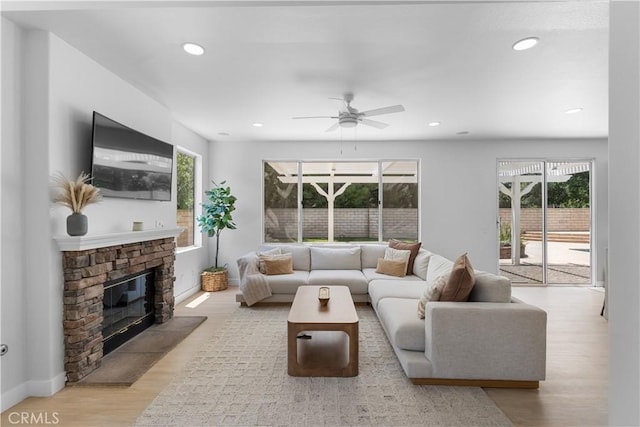2517 Renata Ct, Thousand Oaks, CA 91362 - living area featuring a stone fireplace, wood finished floors, ceiling fan, and recessed lighting