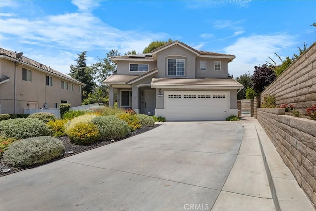 2517 Renata Ct, Thousand Oaks, CA 91362 - traditional-style house with an attached garage, stucco siding, solar panels, a tiled roof, and concrete driveway