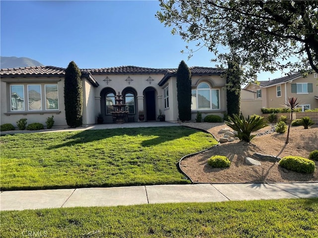 5091 Woodley Ridge Dr, Rancho Cucamonga, CA 91739 - mediterranean / spanish-style home featuring stucco siding, a front lawn, and a tile roof