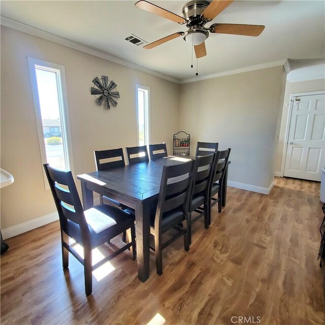 14610 Apple Valley Rd, Apple Valley, CA 92307 - dining area featuring a ceiling fan, wood finished floors, and crown molding