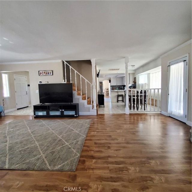 14610 Apple Valley Rd, Apple Valley, CA 92307 - living room featuring crown molding, stairway, wood finished floors, and decorative columns