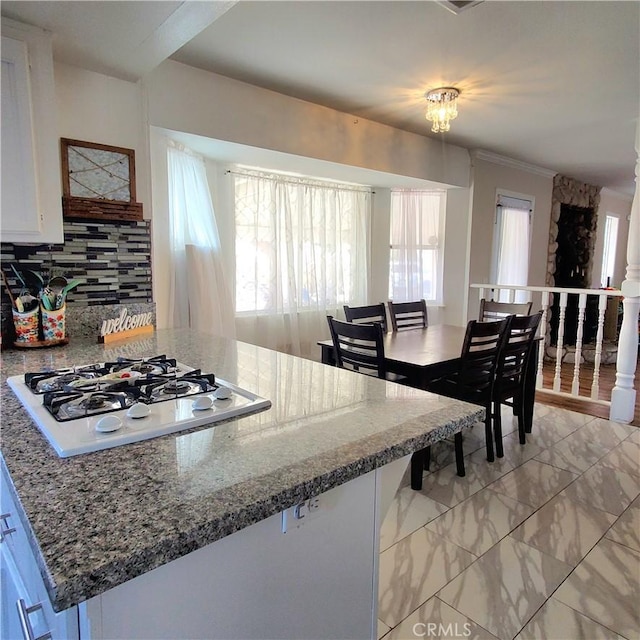 14610 Apple Valley Rd, Apple Valley, CA 92307 - kitchen with white gas cooktop, plenty of natural light, tasteful backsplash, light marble finish flooring, and ornamental molding