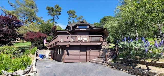 1608 Bradford Rd, Cambria, CA 93428 - chalet / cabin featuring a wooden deck, stairway, and asphalt driveway