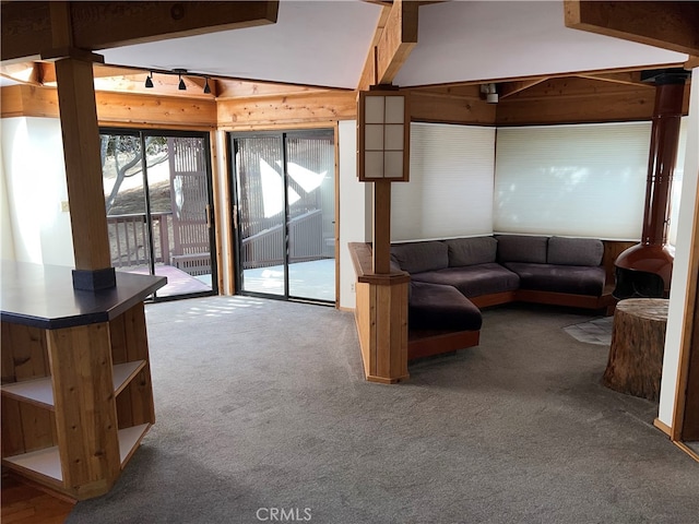 1608 Bradford Rd, Cambria, CA 93428 - living room with carpet floors, lofted ceiling, and wooden walls