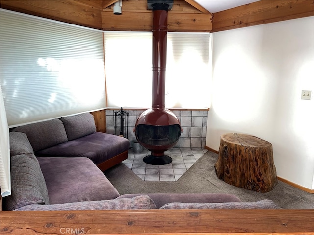 1608 Bradford Rd, Cambria, CA 93428 - carpeted living room featuring a wood stove and vaulted ceiling