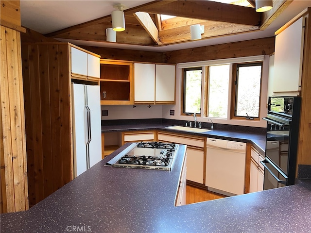 1608 Bradford Rd, Cambria, CA 93428 - kitchen with white appliances, dark countertops, open shelves, white cabinets, and wooden walls