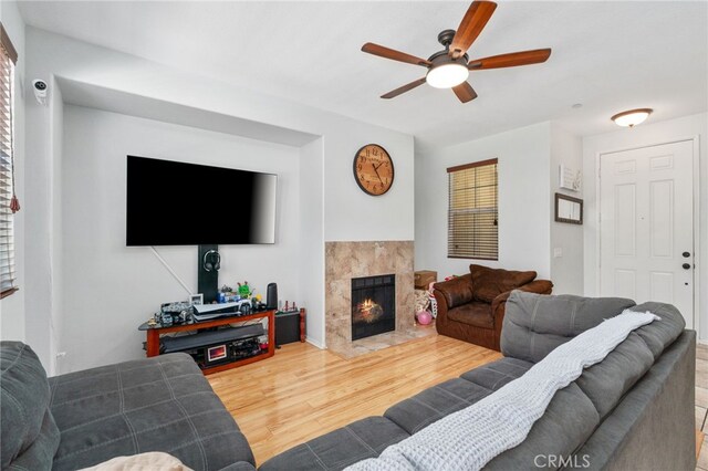 3381 Evening Mist Ln, Perris, CA 92571 - living area with ceiling fan, wood finished floors, and a fireplace