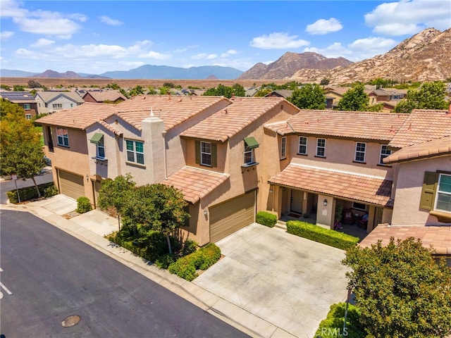 3381 Evening Mist Ln, Perris, CA 92571 - view of front of property featuring a garage, concrete driveway, a tiled roof, a mountain view, and a residential view