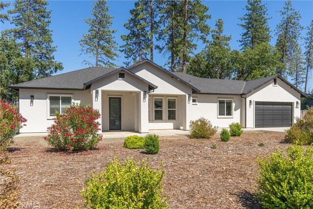 5790 Fickett Ln, Paradise, CA 95969 - ranch-style home with stucco siding and a garage