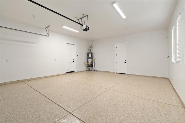 5790 Fickett Ln, Paradise, CA 95969 - garage featuring a garage door opener and strapped water heater