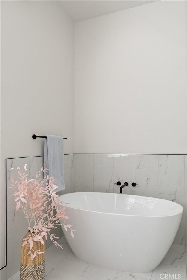 5790 Fickett Ln, Paradise, CA 95969 - full bath featuring marble finish floors, tile walls, a soaking tub, and wainscoting