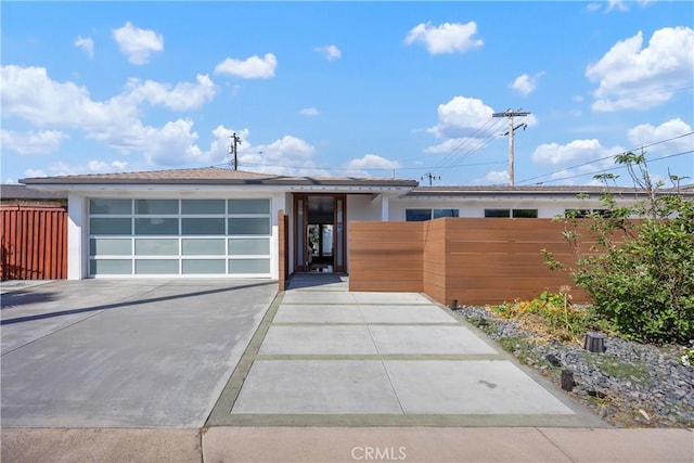 496 E 16th, Costa Mesa, CA 92627 - view of front facade with driveway, stucco siding, and a garage