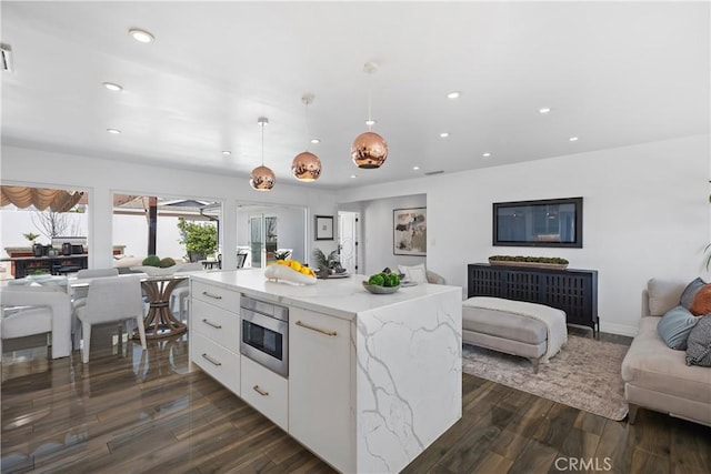 496 E 16th, Costa Mesa, CA 92627 - kitchen featuring open floor plan, white cabinets, recessed lighting, dark wood-style flooring, and stainless steel microwave