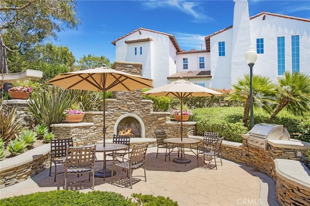 33 Renata, Newport Coast, CA 92657 - view of patio with area for grilling, an outdoor stone fireplace, and outdoor dining area