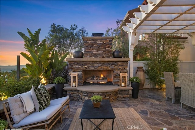 33 Renata, Newport Coast, CA 92657 - patio terrace at dusk with a patio, a pergola, and an outdoor living space with a fireplace