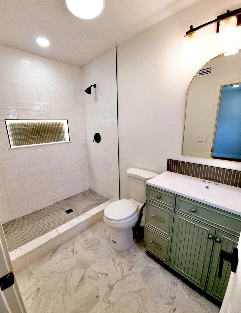 2819 Morningside St, San Diego, CA 92139 - bathroom featuring vanity, tiled shower, marble finish flooring, and recessed lighting