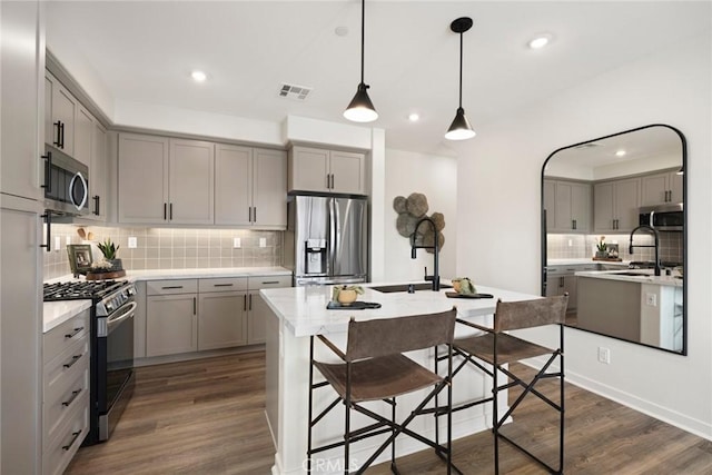 2601 Durfee Ave Unit F, El Monte, CA 91732 - kitchen with stainless steel appliances, gray cabinets, tasteful backsplash, a center island with sink, and recessed lighting