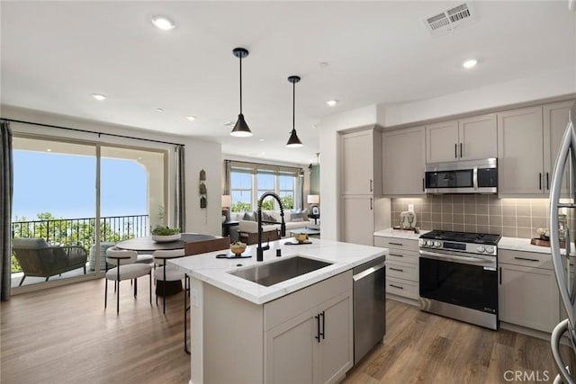 2601 Durfee Ave Unit F, El Monte, CA 91732 - kitchen featuring stainless steel appliances, gray cabinets, wood finished floors, backsplash, and recessed lighting
