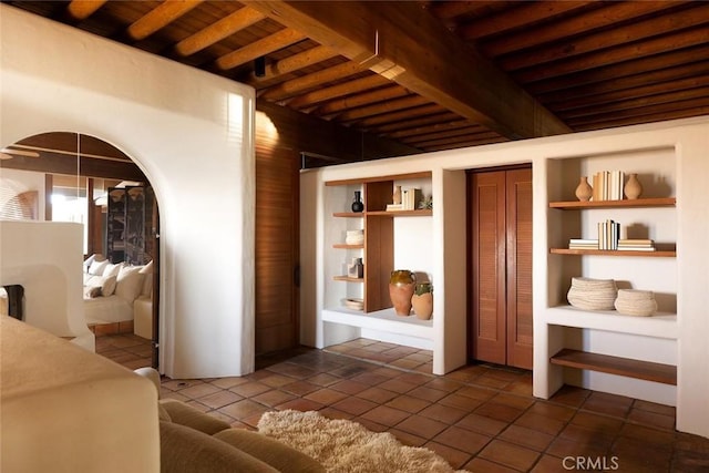 19623 Rd 211, Friant, CA 93626 - living area featuring a wood ceiling with exposed beams, arched walkways, dark tile patterned floors, and built in features