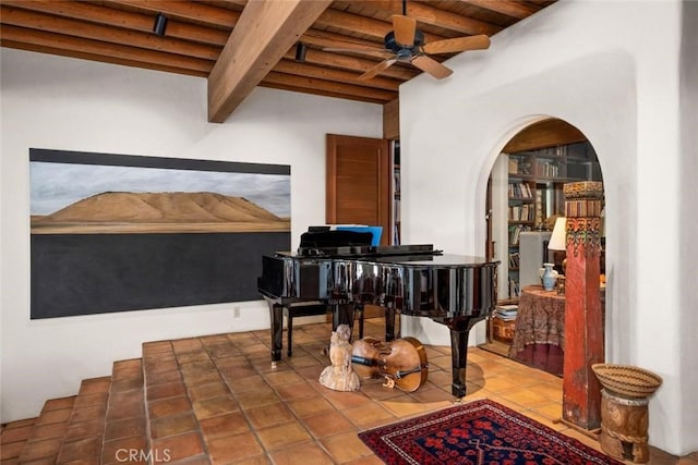 19623 Rd 211, Friant, CA 93626 - living area with a wooden ceiling with exposed beams, a ceiling fan, arched walkways, and tile patterned flooring