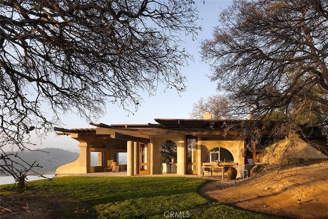 19623 Rd 211, Friant, CA 93626 - back of house featuring a yard, a patio, and stucco siding