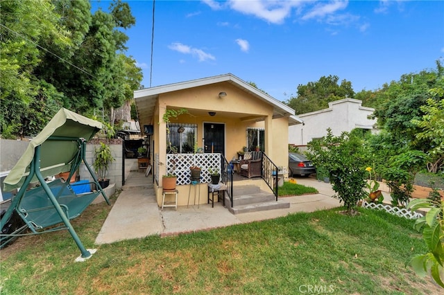 1153 Isabel St, Los Angeles, CA 90065 - view of front facade featuring stucco siding, a patio, and a front lawn