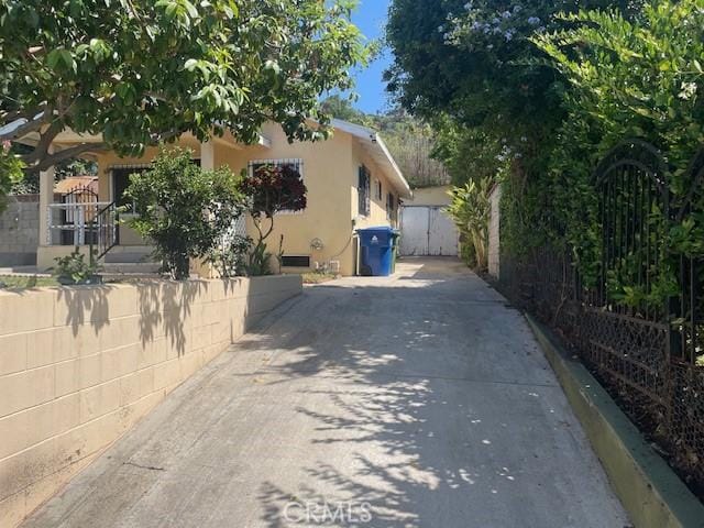 1153 Isabel St, Los Angeles, CA 90065 - view of property exterior featuring concrete driveway, a gate, and stucco siding