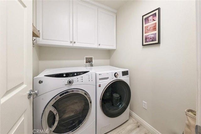 64 Full Moon, Irvine, CA 92618 - laundry area featuring washer and clothes dryer, cabinet space, and light wood-style flooring
