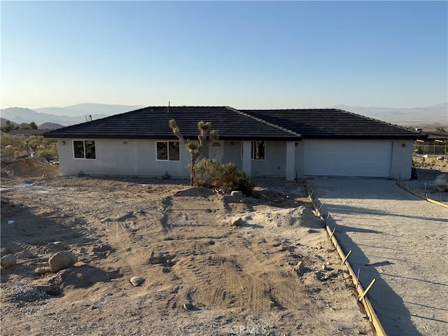 32224 Emerald, Lucerne Valley, CA 92356 - ranch-style house with an attached garage, concrete driveway, stucco siding, and a mountain view