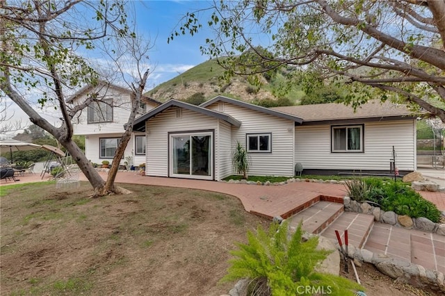 9707 Foothill Blvd, Sylmar, CA 91342 - back of property featuring a mountain view and a patio area