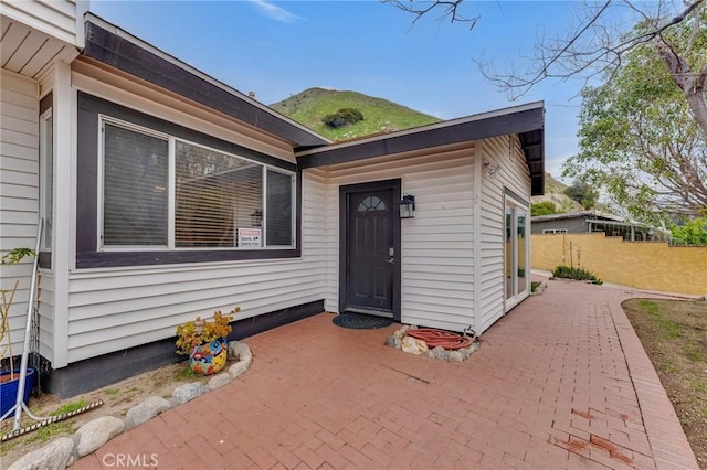 9707 Foothill Blvd, Sylmar, CA 91342 - view of exterior entry featuring a patio area and a mountain view