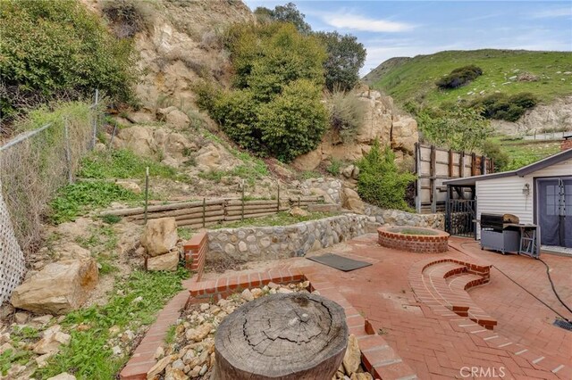 9707 Foothill Blvd, Sylmar, CA 91342 - fenced backyard with a grill, a patio, and an outdoor fire pit