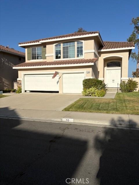10 Via Berrendo, Rancho Santa Margarita, CA 92688 - view of front facade featuring a garage, a tiled roof, stucco siding, concrete driveway, and a front yard
