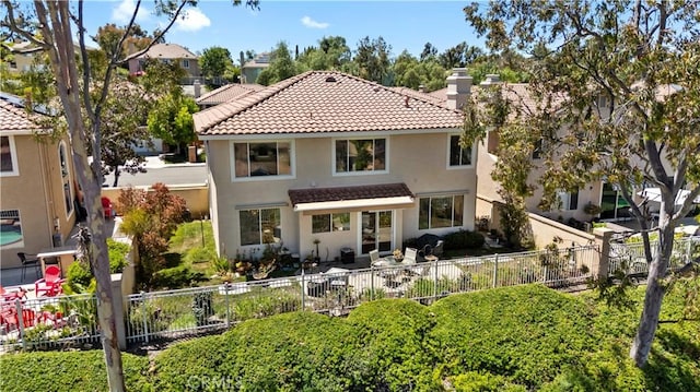 10 Via Berrendo, Rancho Santa Margarita, CA 92688 - rear view of property with stucco siding, a fenced backyard, a chimney, a tiled roof, and a patio area