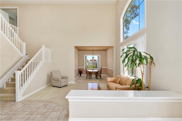 10 Via Berrendo, Rancho Santa Margarita, CA 92688 - living area with a towering ceiling, stairs, and a chandelier