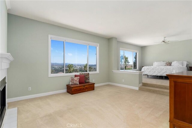 10 Via Berrendo, Rancho Santa Margarita, CA 92688 - bedroom featuring light carpet, a fireplace, and a ceiling fan