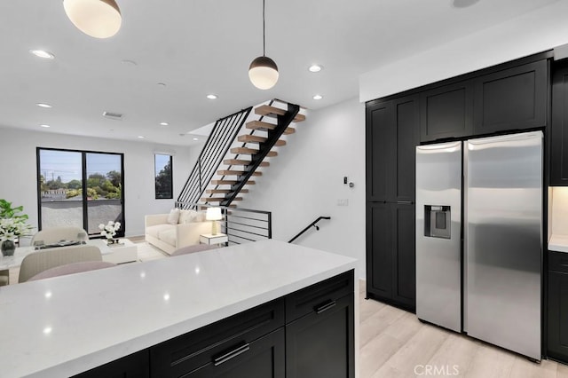 11304 Victory Blvd, North Hollywood, CA 91606 - kitchen featuring stainless steel fridge, dark cabinetry, light countertops, and recessed lighting