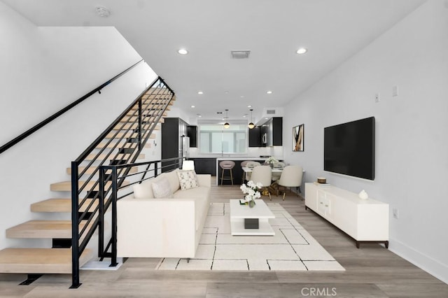 11304 Victory Blvd, North Hollywood, CA 91606 - living area with stairs, wood finished floors, and recessed lighting