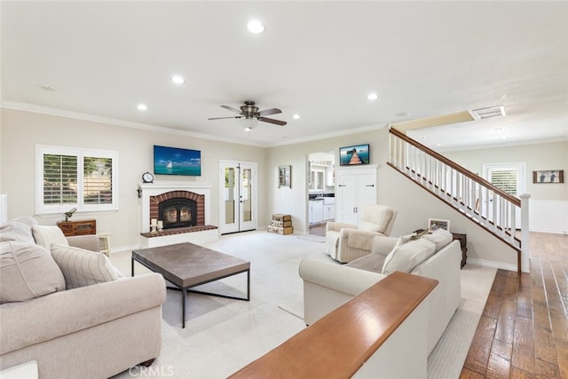 41559 Floyd Ct, Temecula, CA 92592 - living area with recessed lighting, stairs, healthy amount of natural light, crown molding, and a brick fireplace