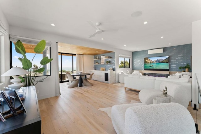 5530 Candlelight Dr, La Jolla, CA 92037 - living area featuring plenty of natural light, a wall mounted AC, light wood-style flooring, and recessed lighting