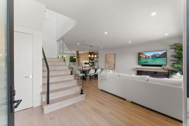 5530 Candlelight Dr, La Jolla, CA 92037 - living area featuring stairway, recessed lighting, wood finished floors, and a chandelier