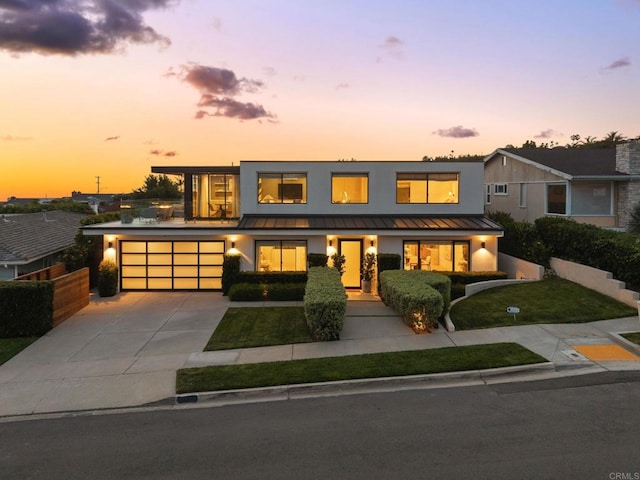 5530 Candlelight Dr, La Jolla, CA 92037 - contemporary house with a standing seam roof, concrete driveway, stucco siding, and a metal roof