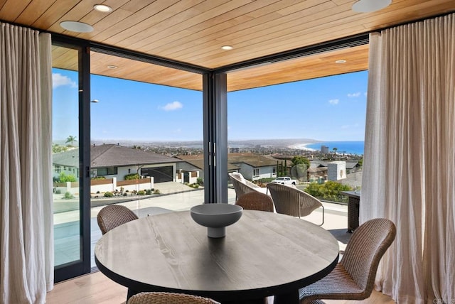 5530 Candlelight Dr, La Jolla, CA 92037 - dining room featuring a wall of windows, wood finished floors, and wood ceiling