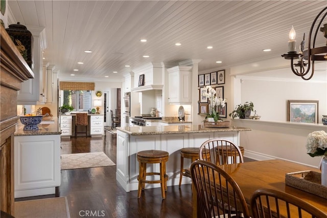 126 Monarch Bay, Dana Point, CA 92629 - kitchen with dark wood-style flooring, white cabinets, ornamental molding, recessed lighting, and light stone countertops