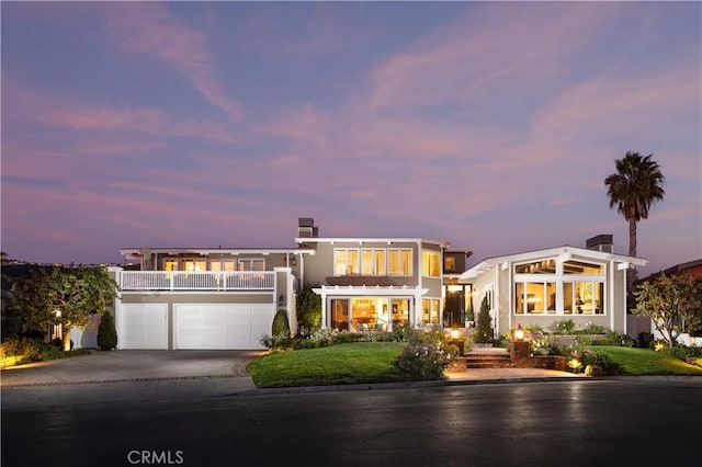 126 Monarch Bay, Dana Point, CA 92629 - view of front of house featuring driveway, a garage, a balcony, and a chimney